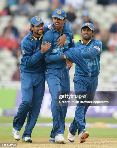 Sri Lanka's Sachithra Senanayake is congratulated by teammates Tillakaratne Dilshan and Ashan Priyanjan after finishing his bowling spell during the...