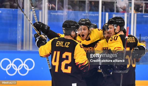 Dpatop - Players of the Germany men's national ice hockey team celebrate their 1st goal during the Group C men's ice hockey match between Germany and...