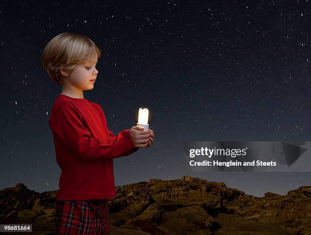 boy with energy saving light bulb - american football league stock pictures, royalty-free photos & images
