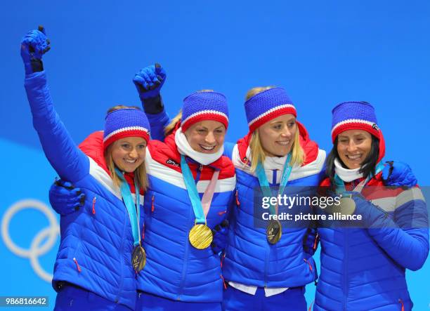 Dpatop - Norwegian gold medallists Ingvild Flugstad Oestberg , Astrid Uhrenholdt Jacobsen, Ragnhild Haga and Marit Bjoergen celebrate on the podium...