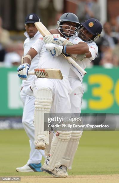 Kumar Sangakkara of Sri Lanka is congratulated on reaching his century by teammate Mahela Jayawardene during the 1st Test match between England and...