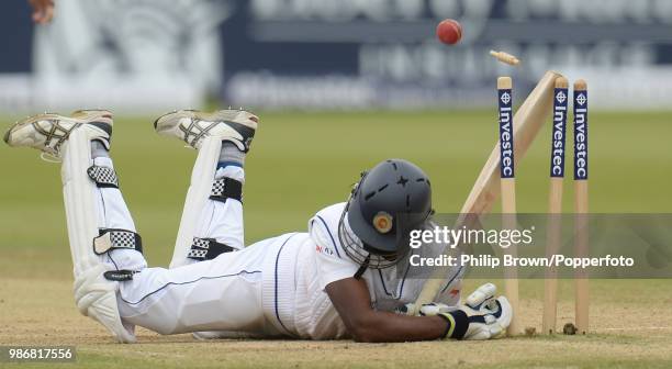 Nuwan Pradeep of Sri Lanka falls onto his stumps and is out hit wicket during the 1st Test match between England and Sri Lanka at Lord's Cricket...