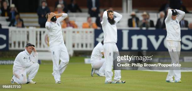 England's Ian Bell, Gary Ballance, Alastair Cook , Moeen Ali and Joe Root react after Sri Lanka's last pair of batsmen play out the last ball of the...