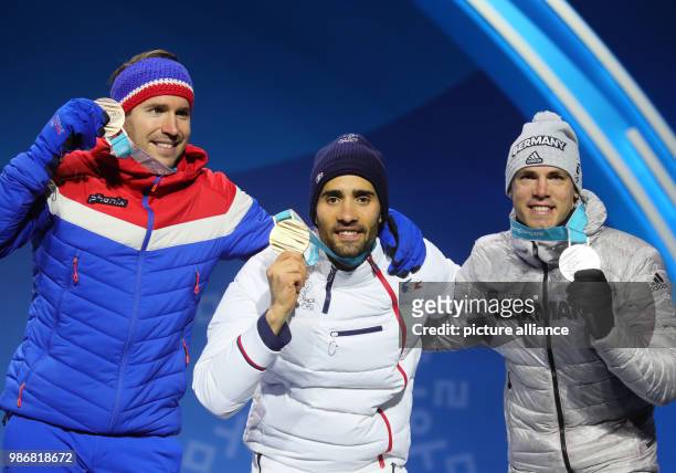 February 2018, South Korea, Pyeongchang: Olympics, Biathlon, Men's Mass Start, Award Ceremony at Medal Plaza: Emil Hegle Svendsen from Norway , Simon...
