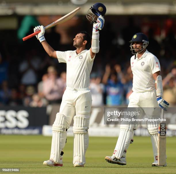 Ajinkya Rahane of India celebrates reaching his century during his innings of 103 with teammate Mohammed Shami during the 2nd Test match between...