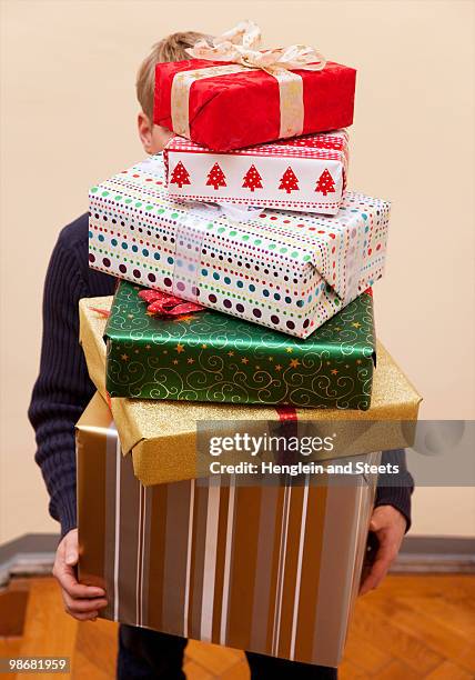 man carrying pile of  presents - medium group of objects stock pictures, royalty-free photos & images