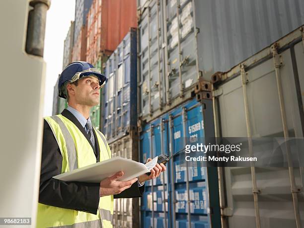 businessman with shipping containers - vrachtruimte stockfoto's en -beelden