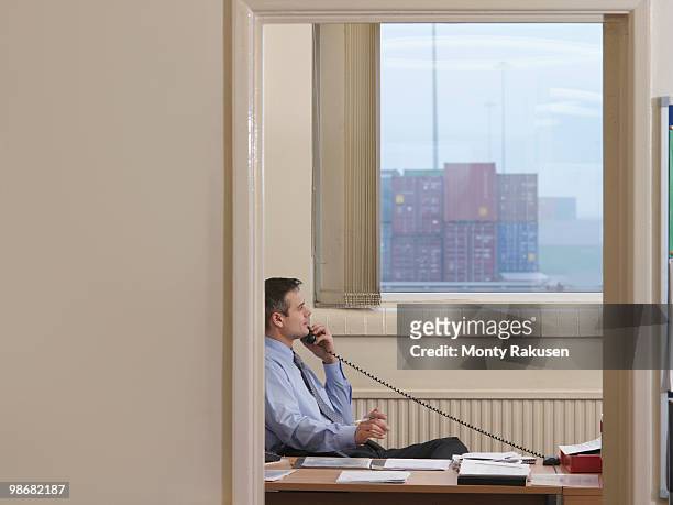 businessman on telephone in port - vrachtruimte stockfoto's en -beelden