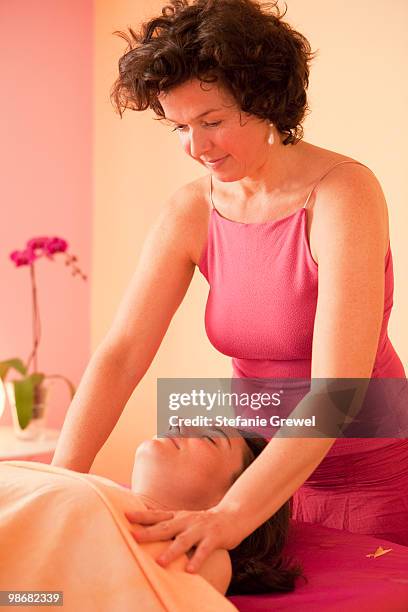 woman getting a massage - dießen stock-fotos und bilder
