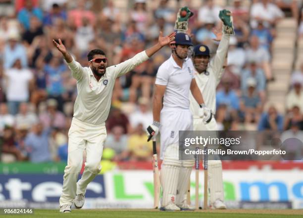 Ravi Jadeja of India appeals successfully for the wicket of England captain Alastair Cook, caught behind by Mahendra Singh Dhoni for 95 runs, during...