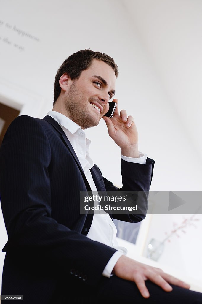 Smiling man using cell phone