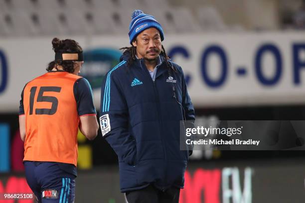 Blues coach Tana Umaga watches the team warm up prior to the round 17 Super Rugby match between the Blues and the Reds at Eden Park on June 29, 2018...