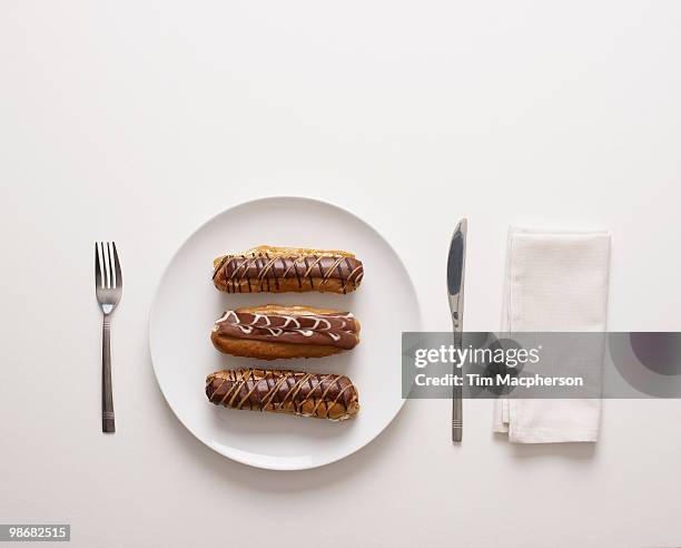 a plate of cream cakes - eclairs stock pictures, royalty-free photos & images