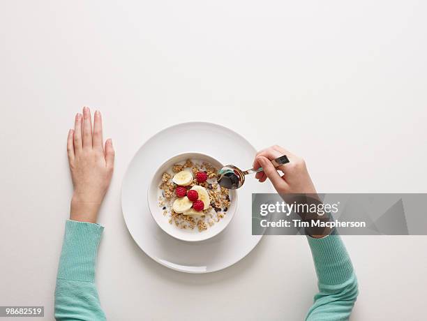 hands by a bowl of cereal - child arms raised stock pictures, royalty-free photos & images