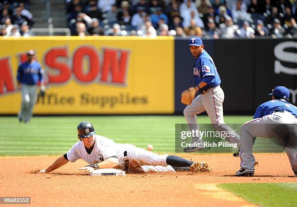 Brett Gardner of the New York Yankees steals second base as Elvis Andrus of the Texas Rangers misses the throw from the catcher in the bottom of the...