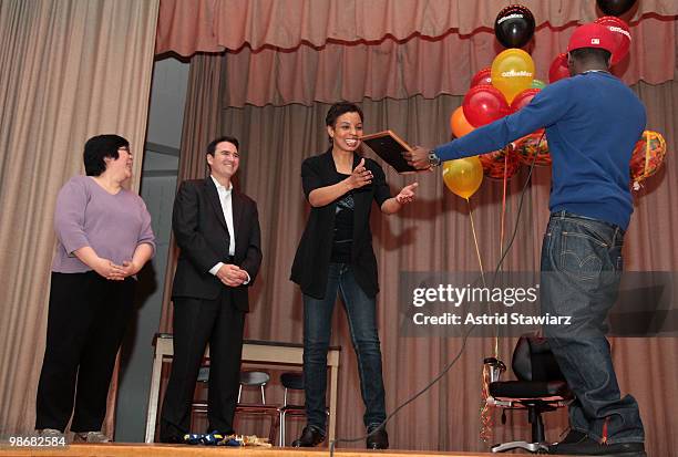 Phyllis Tam and senior director of external relations at OfficeMax Bill Bonner watches Middle School 131 Dance Teacher Margaret Plaza being honored...