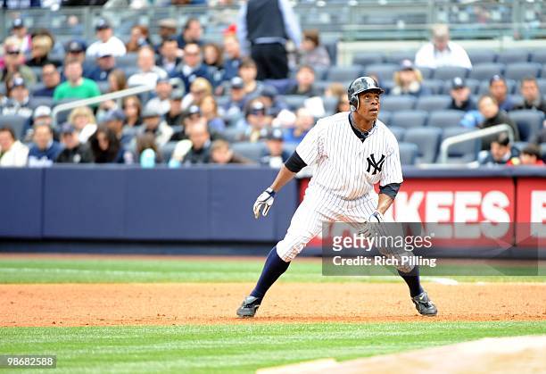 Curtis Granderson of the New York Yankees takes a lead off first base during the game against the Texas Rangers at Yankee Stadium in the Bronx, New...