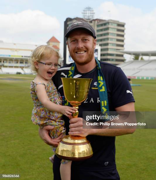 Yorkshire's suspended captain Andrew Gale holds his daughter and the County Championship trophy after Yorkshire won the LV County Championship with...