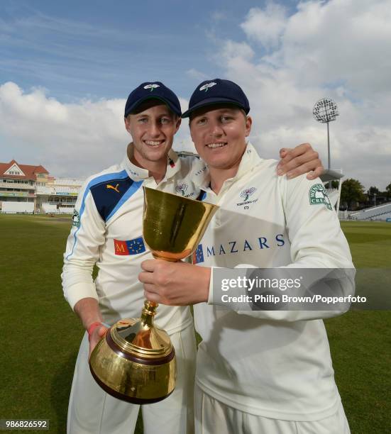 Joe Root and Gary Ballance of Yorkshire celebrate with the County Championship trophy after Yorkshire won the LV County Championship with victory...