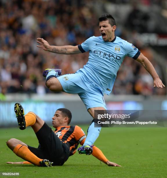 Sergio Aguero of Manchester City is tackled by Curtis Davies of Hull City during the Premier League match between Hull City and Manchester City at...