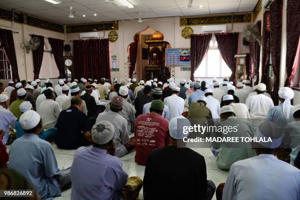 Thai Muslims attend a Friday prayer in Ban Ao Manow mosque in Narthiwat province on June 29, 2018 where a special prayer was made for the safety and...