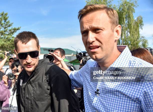 Russian opposition leader Alexei Navalny walks with his younger brother Oleg in the village of Naryshkino, in the Oryol region south of Moscow, on...