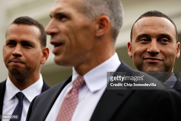 World Series champion New York Yankees players Alex Rodriguez and Derek Jeter stand behind team manager Joe Girardi while talking to the news media...