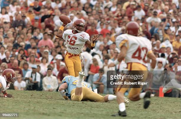 Rodney Peete of the USC Trojans passes during the game against the UCLA Bruins at the Rose Bowl on November 19, 1988 in Pasadena, California.