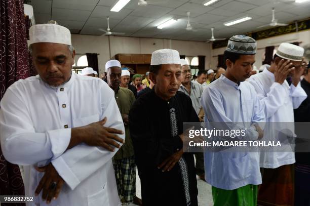 Thai Muslims attend a Friday prayer in Ban Ao Manow mosque in Narthiwat province on June 29, 2018 where special prayer was made for the safety and...