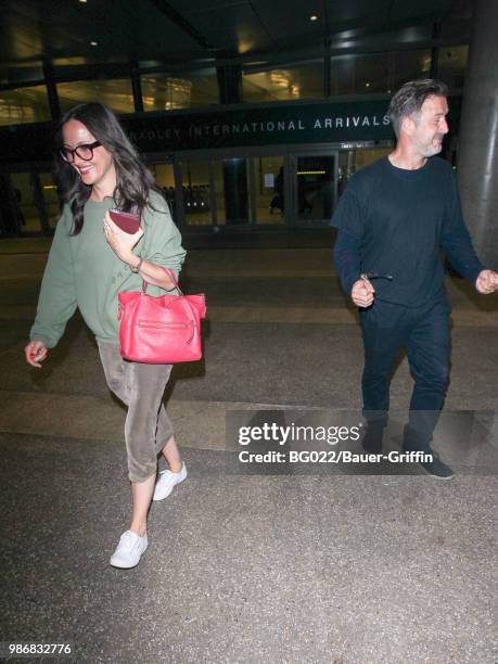Christina McLarty and David Arquette are seen at Los Angeles International Airport on June 28, 2018 in Los Angeles, California.