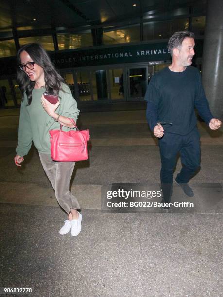 Christina McLarty and David Arquette are seen at Los Angeles International Airport on June 28, 2018 in Los Angeles, California.