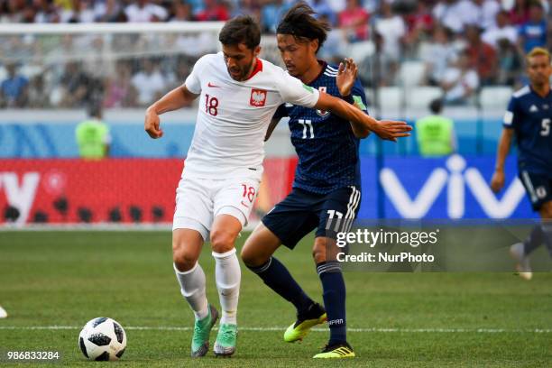 Bartosz Bereszynski of Poland and Takashi Usami of Japan during the 2018 FIFA World Cup Group H match between Japan and Poland at Volgograd Arena in...