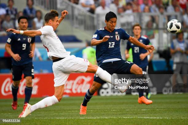 Yoshinori Muto of Japan and Jan Bednarek of Poland during the 2018 FIFA World Cup Group H match between Japan and Poland at Volgograd Arena in...