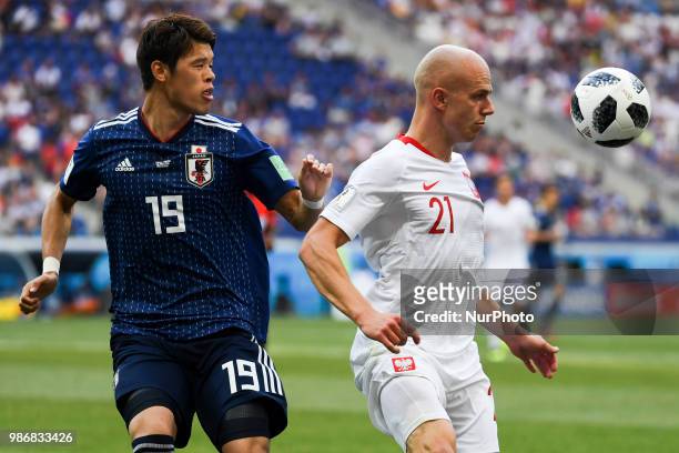 Rafal Kurzawa of Poland controls the ball and Hiroki Sakai of Japan during the 2018 FIFA World Cup Group H match between Japan and Poland at...