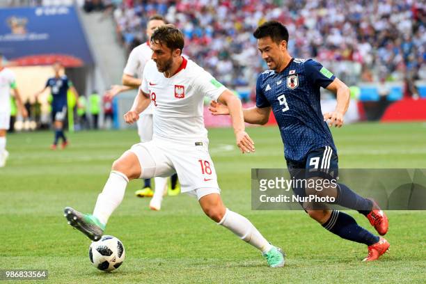 Batrosz Bereszynski of Poland and Shinji Okazaki of Japan fight for the ball during the 2018 FIFA World Cup Group H match between Japan and Poland at...