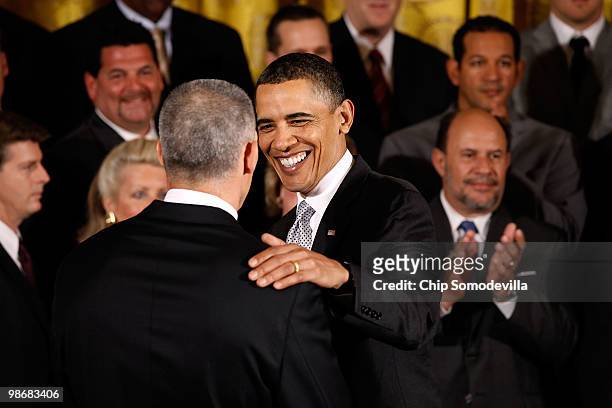 President Barack Obama congratulates New York Yankees Manager Joe Girardi during a ceremony with the World Series champs in the East Room of the...