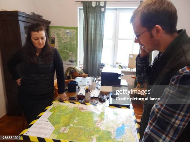 January 2018, Poland, Bialowieza: Environmental activits Joanna Pawluskiewicz and Michal point to the Bialowieza primeval forest on a map. Photo:...