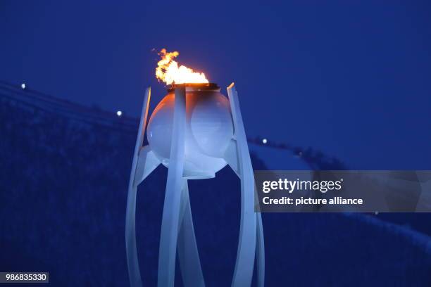 February 2018, South Korea, Pyeongchang, Olympics: The Olympic flame can be spotted in the second week of the games during sundown. Photo: Michael...