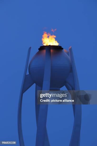 February 2018, South Korea, Pyeongchang, Olympics: The Olympic flame can be spotted in the second week of the games during sundown. Photo: Michael...