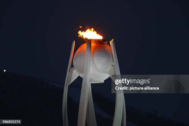 February 2018, South Korea, Pyeongchang, Olympics: The Olympic flame can be spotted in the second week of the games during sundown. Photo: Michael...