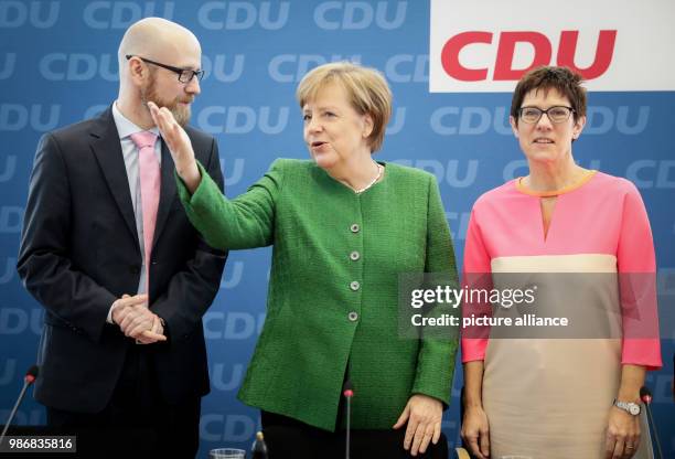 German chancellor and Chairwoman of the Christian Democratic Union, Angela Merkel , talks with Annegret Kramp-Karrenbauer , premiere of Saarland and...