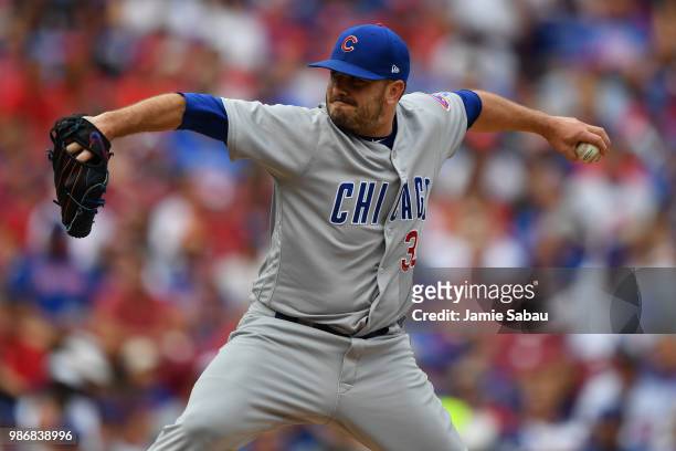 Brian Duensing of the Chicago Cubs pitches against the Cincinnati Reds at Great American Ball Park on June 23, 2018 in Cincinnati, Ohio.