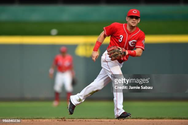 Scooter Gennett of the Cincinnati Reds fields a ground ball against the Chicago Cubs at Great American Ball Park on June 23, 2018 in Cincinnati, Ohio.