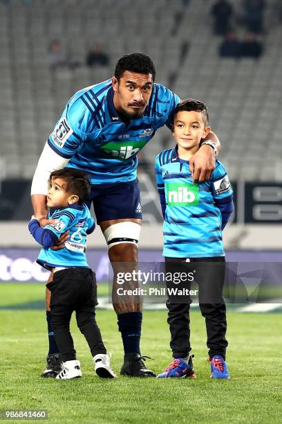 Jerome Kaino of the Blues runs out onto the field with his children during the round 17 Super Rugby match between the Blues and the Reds at Eden Park...