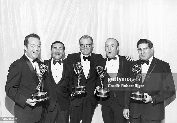 Robert Riger, Chet Forte, Roone Arledge , Charles Fox and an unidentified person pose with Emmy Awards for ABC TV's Wide World of Sports, circa 1970.