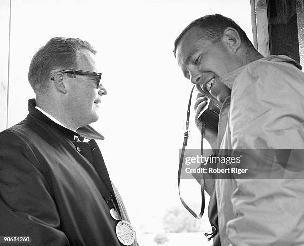 Executive Producer of ABC's Wide World of Sports Roone Arledge looks on as Producer Chuck Howard speaks on the phone following their broadcast of the...