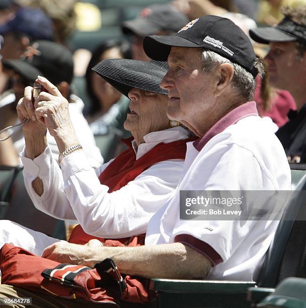 Former President George H.W. Bush and Barbara Bush attend a baseball game between the Pittsburgh Pirates and the Houston Astros at Minute Maid Park...