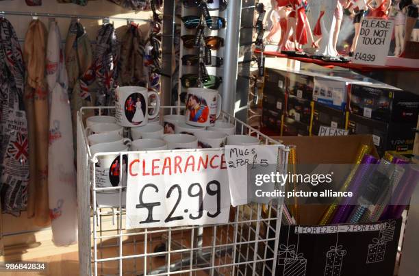 Febuary 2018, England, Windsor: A basket with a sign reading "Clearance" in a souvenir shop is filled with mugs bearing the image of Prince William...