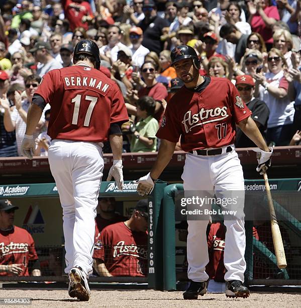 Lance Berkman of the Houston Astros receives congratulations from Pedro Feliz after hitting a home run in the second inning against the Pittsburgh...