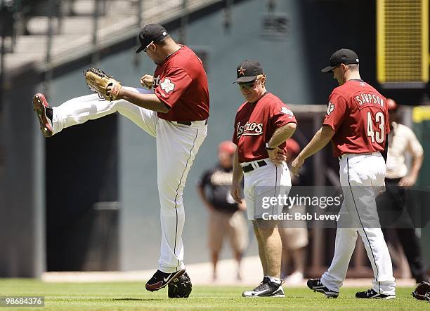 Carlos Lee of the Houston Astros kicks the glove of pitcher Chris Sampson during warm ups before the Pittsburgh Pirates and Houston Astros baseball...